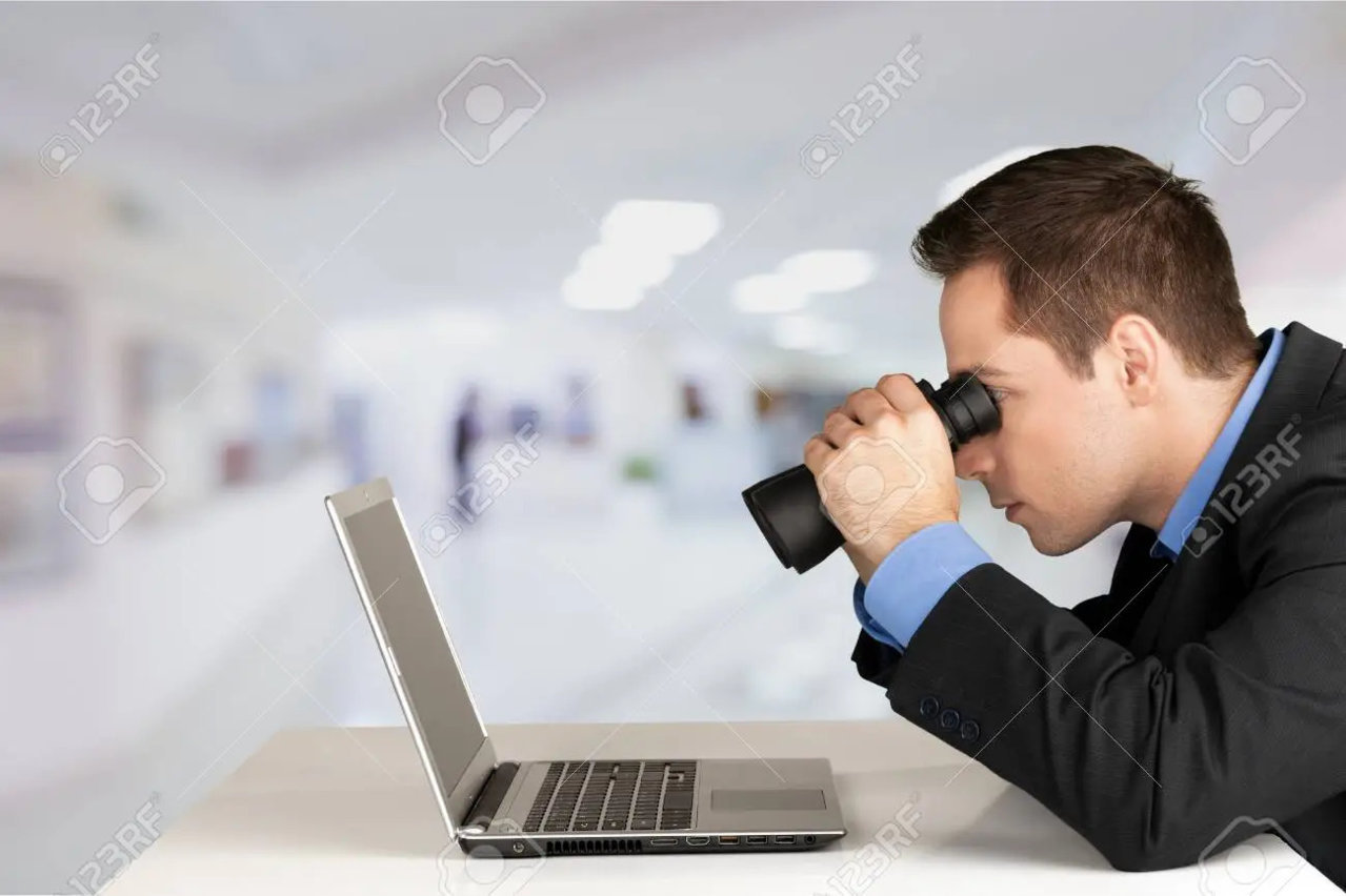 108681204-man-searching-in-laptop-with-binoculars.jpg