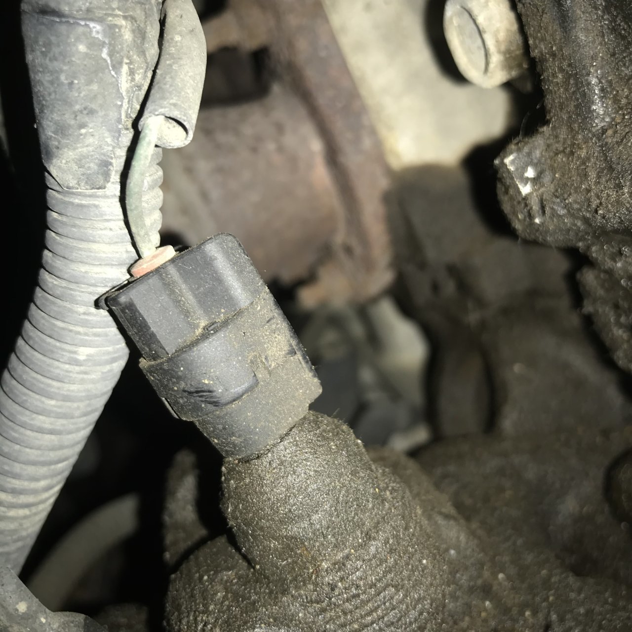 Oil buildup on side of engine near dipstick.