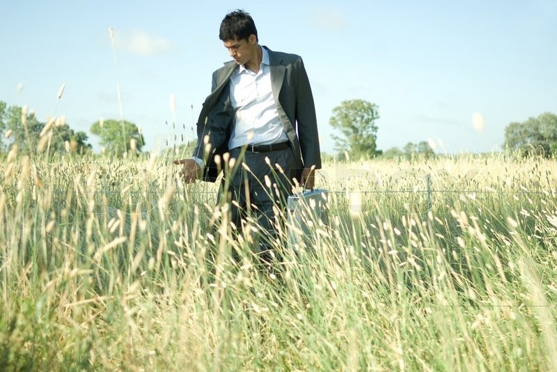 1549645-eric-audras-altopress-maxppp-businessman-walking-through-field.jpg