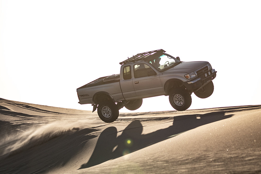 1st-gen-tacoma-dune-jump-sunset-web.jpg