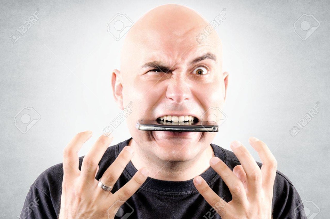 20504025-bald-guy-eating-mobile-phone.jpg