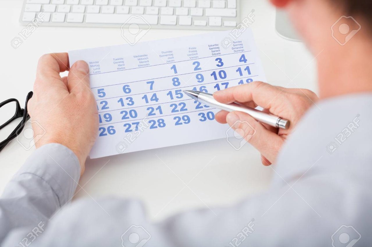 25154436-close-up-of-man-marking-with-pen-and-looking-at-date-on-calendar.jpg