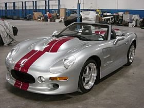 280px-ShelbySeries1_Silver-RedStripe.jpg