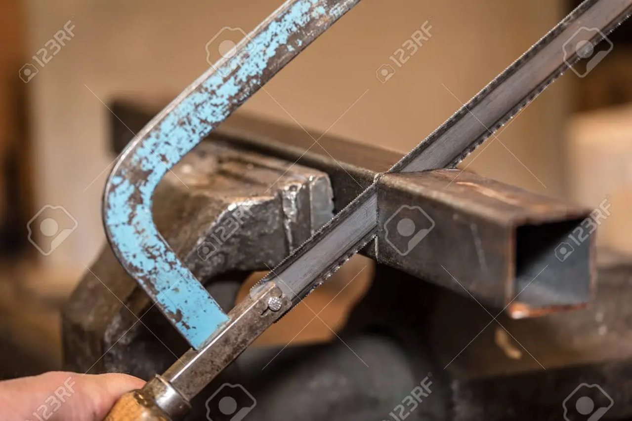78993914-industrial-engineer-working-on-cutting-a-metal-with-handsaw.jpg