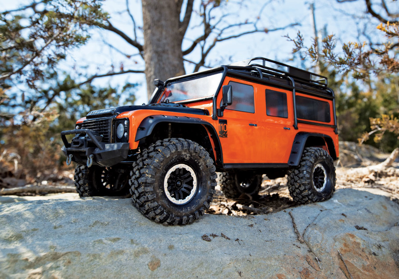 82056-4-Defender-Orange-woods-rock-3qtr-front-left.jpg