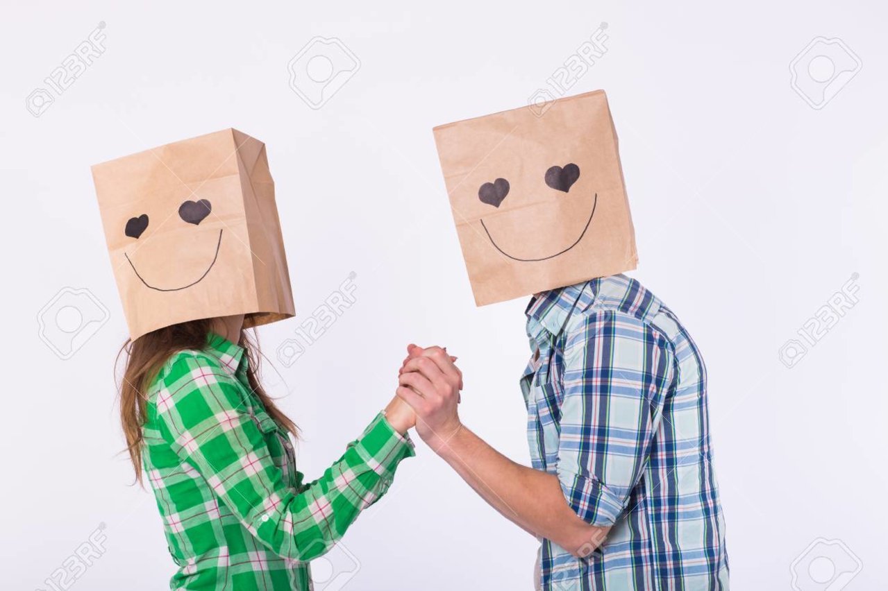 97115206-love-couple-covering-their-faces-with-paper-bag-over-white-background-.jpg