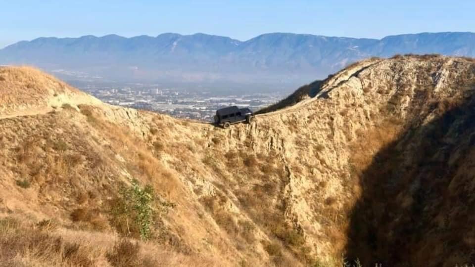 a-jeep-wrangler-is-hanging-off-a-mountain-ridge-on-a-narrow-bike-trail_1.jpg