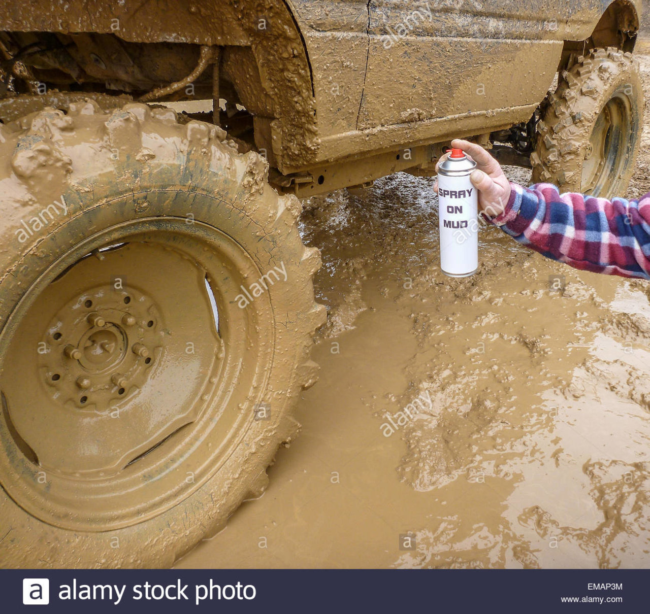 aerosol-spray-on-mud-next-to-an-off-road-suv-vehicle-covered-in-mud-EMAP3M.jpg