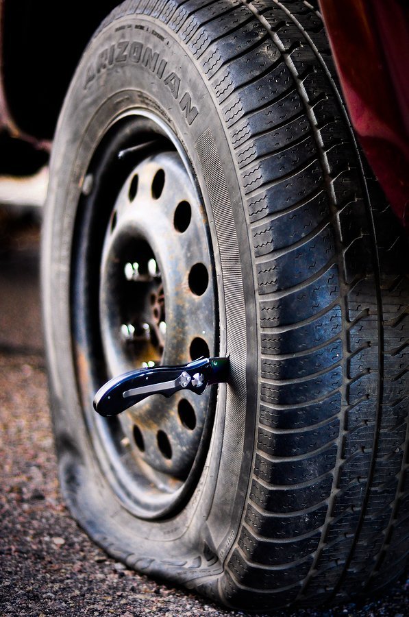 bigstock-knife-in-tire-10979330.jpg
