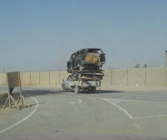 car-photo-pickup-truck-carrying-salvage-toyota-4runner-on-back-bed-making-turn.jpg