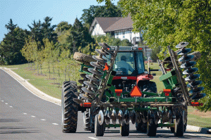 combine_tractor_driving_on_highway_mississippi_state_university_facebook.gif