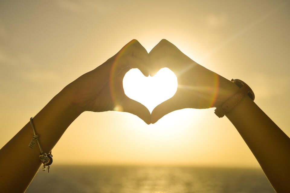 hands-held-in-heart-shape-at-sunset.jpg