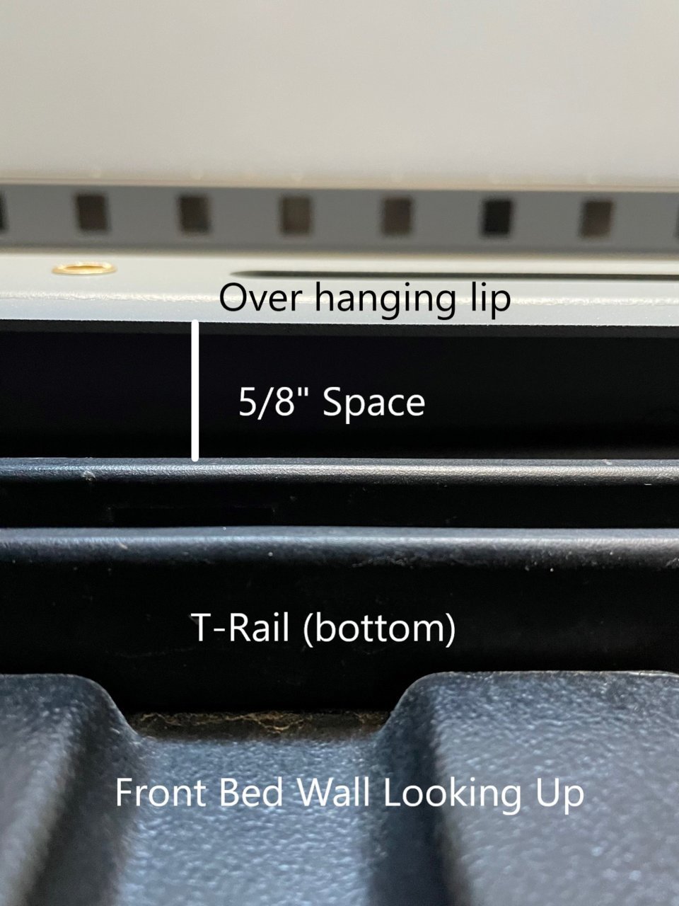 Looking Up under T-Rail and Camper Frame Lip.jpg