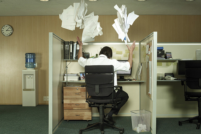 man-at-desk-throwing-papers-in-the-air.jpg
