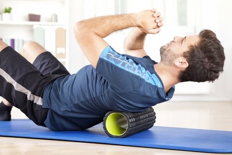 man-lying-on-a-foam-roller-while-doing-an-exercise-royalty-free-image-509421384-1545148853.jpg