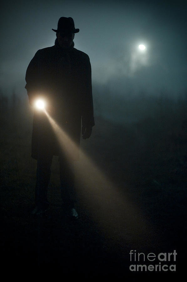 man-searching-at-night-with-a-torch-or-flashlight-lee-avison.jpg