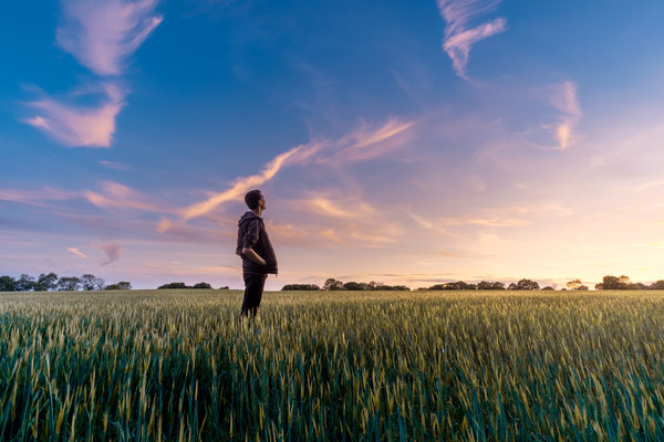 Man-standing-alone-on-rice-field-Stock-Photo.jpg