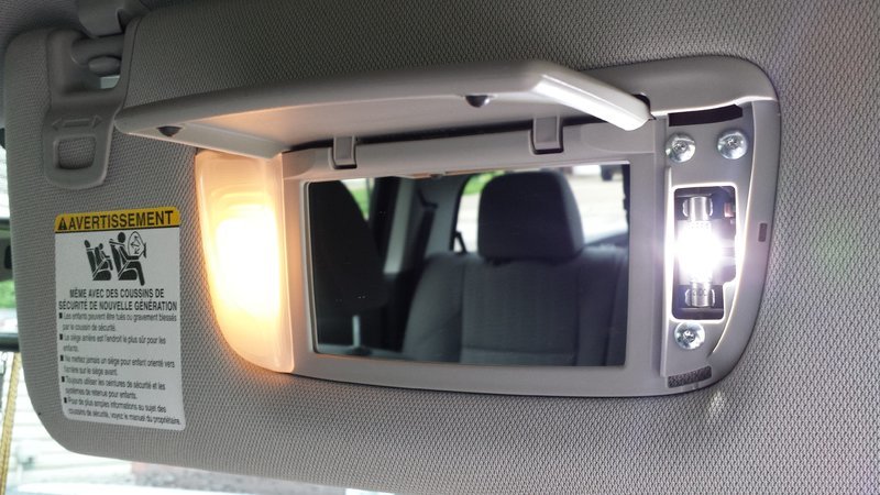 Passenger_vanity_mirror_lights_stock_vs_LED.jpg