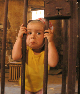 Prison-boy-behind-bars.gif