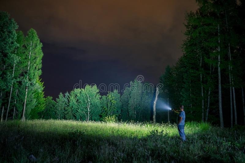 searching-flashlight-outdoor-man-pointing-to-forest-night-120790969.jpg