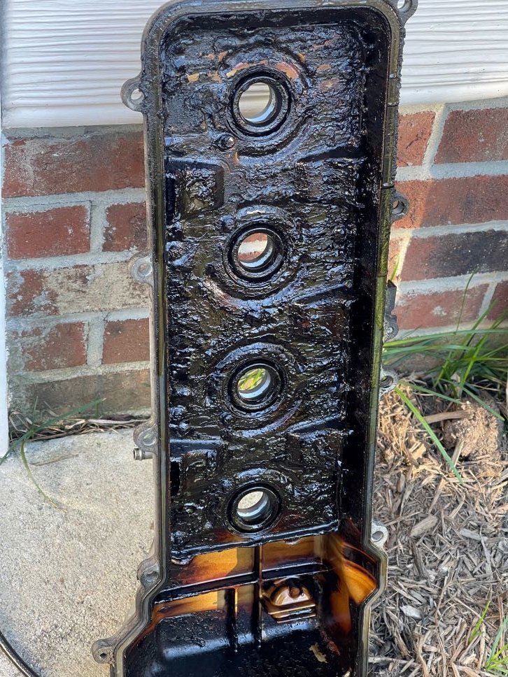 Sludge under valve cover initially.jpg