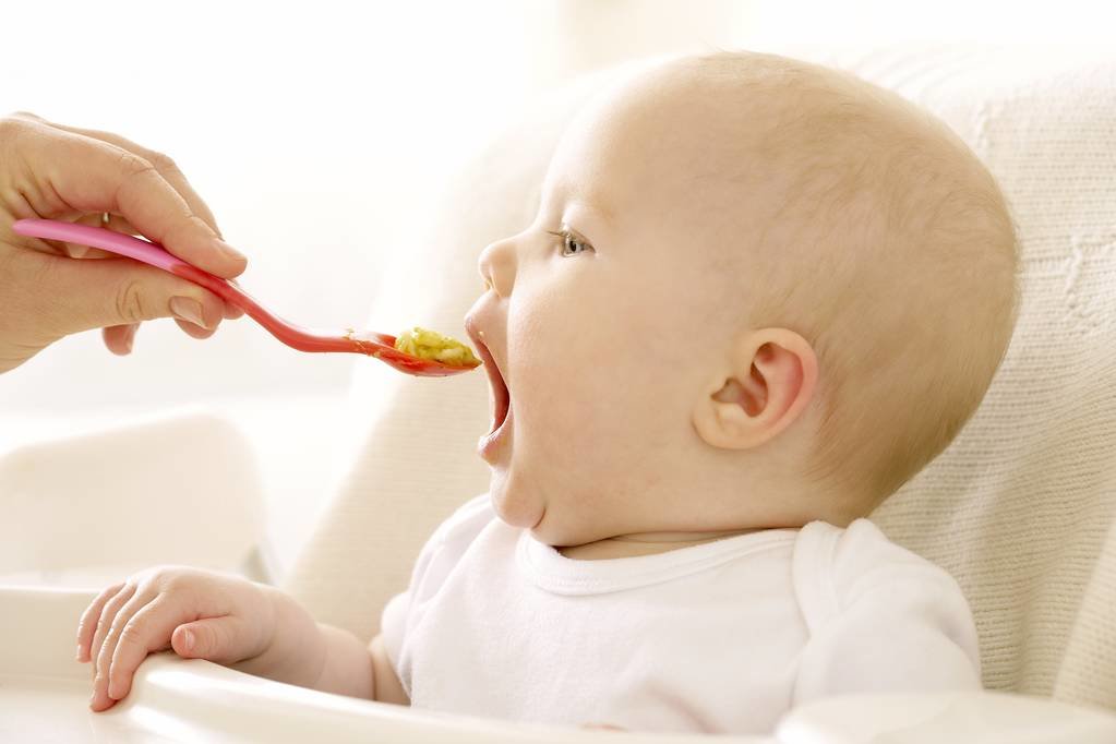 stock-photo-baby-girl-eating-spoon-high.jpg