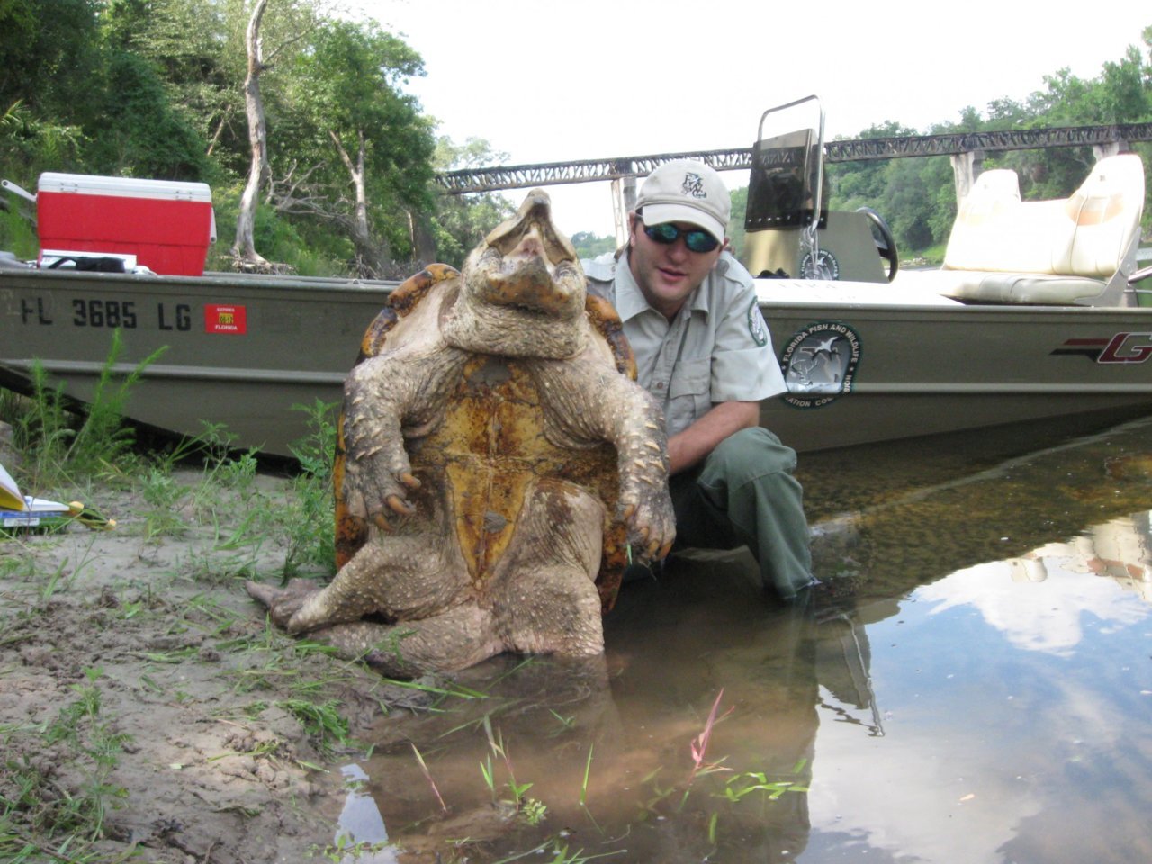 Travis-with-turtle-on-bankPhoto-1.jpg