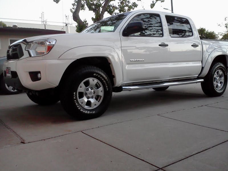 Truck with mud flaps taken off and tube steps on.jpg