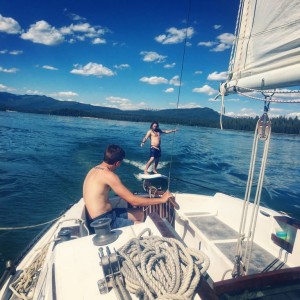 sup surfing a sailboat