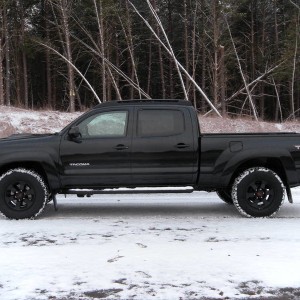 side view of the new tires and wheels in the snow.