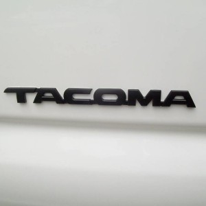 Black TACOMA badges on doors