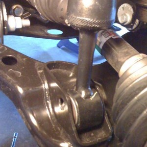 remove lower shock mount bolt
