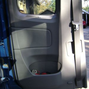 Fire extinguisher in access cab AC rear door