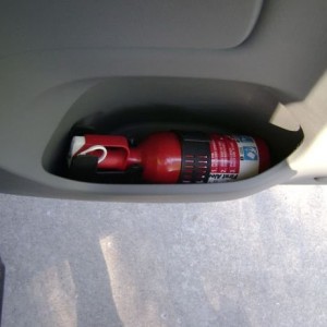 Fire extinguisher in access cab AC rear door