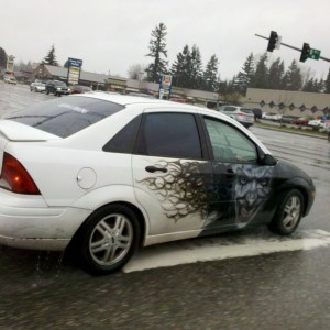 Wtf? Lol joker on a ford focus tatoo car... with an old grandma driving