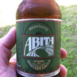 Ice cold beer in hand and chicken on the grill.