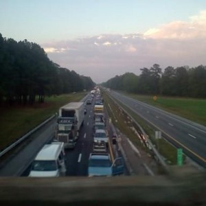 95 south at a dead stop. theres tractor trialers flipped over from the torn