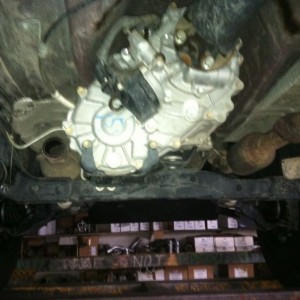 Fixing that stupid exhaust hang down thing. And I had a leak