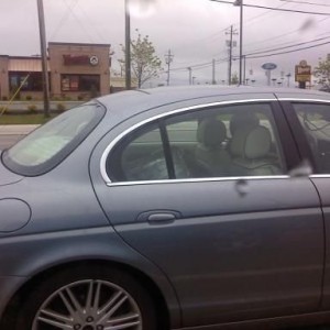 keg in a jaguar without a seat belt. i bet that would get hairy in an accid