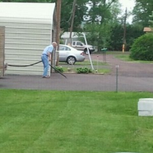 Vaccuming his driveway