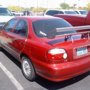BMW rims on a Kia and check out the whale fin bahahahahaha EPIC FAIL