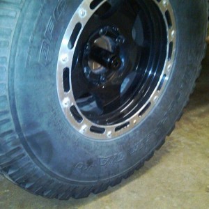 Good way to crack the axel nut loose. Put the wheel back on and set the tru