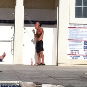 Dude is shaving at the pool shower. WTF