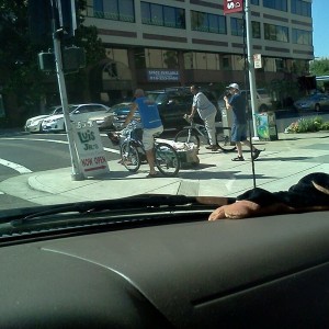 old lady on a scooter with a wheel barrow