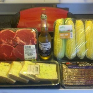 Dinner on the grill. Blacker pepper wrapped fillet mignon, corn on the cob 