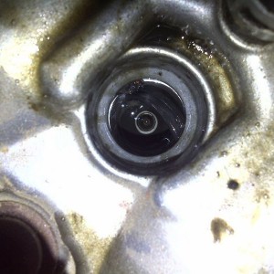 Moar. Spark plug is sitting in a bunch of oil/coolant? Wtf?