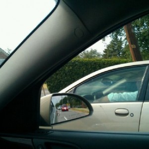 Hard to tell but the dumb ass has his iPad draped over his steering wheel. 