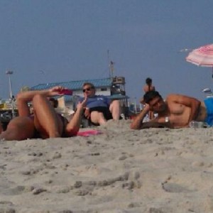 Artie Lange on seaside beach. Fat guy blue shirt