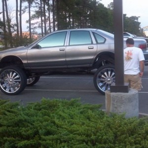 This car is taller than this guy and has 28's on it. WTF