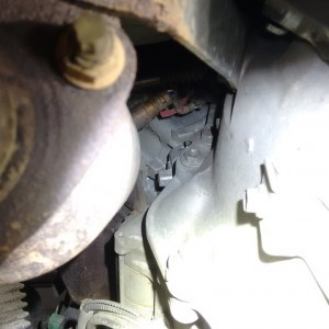 Block heater port as seen under truck